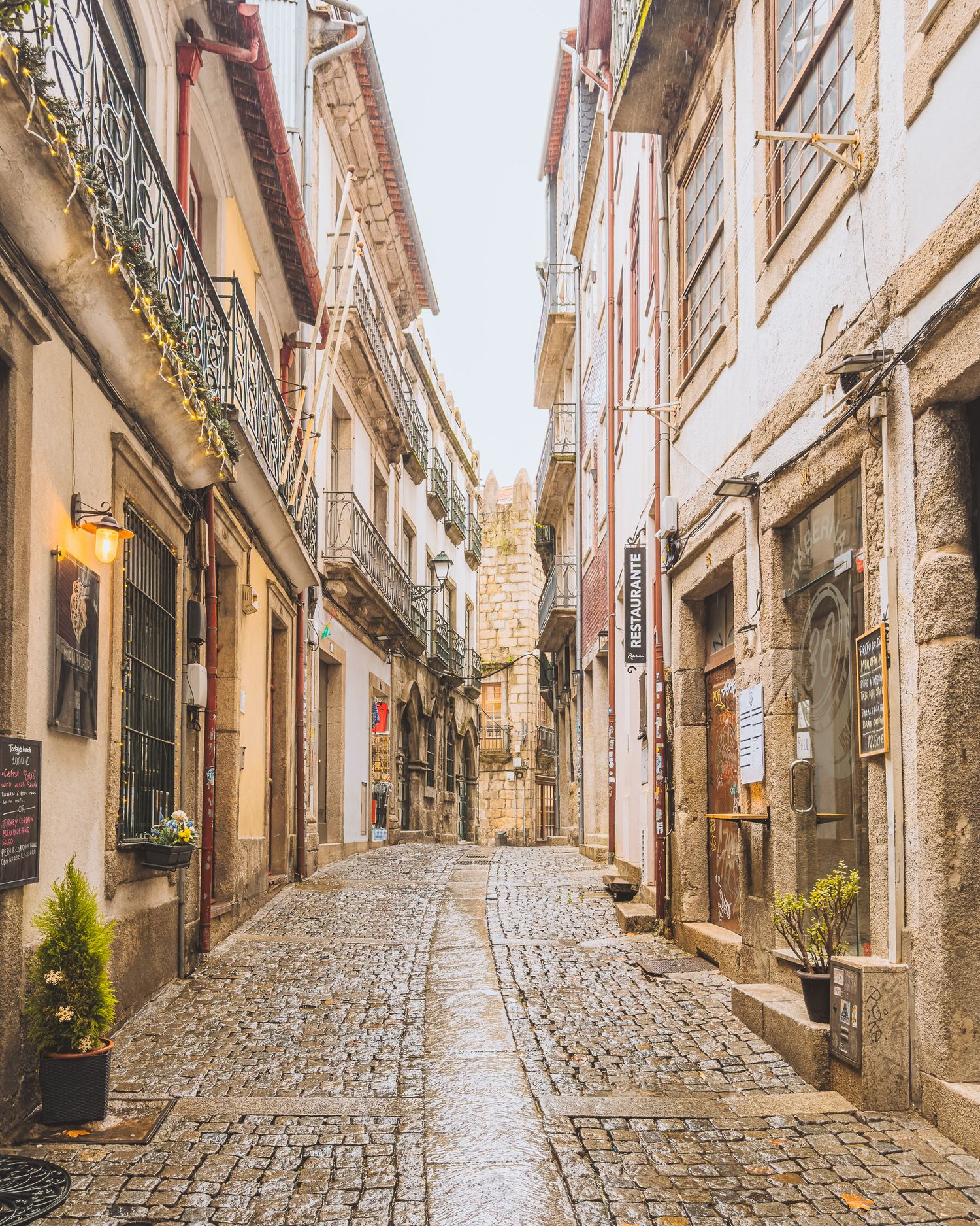 Cobblestone street lined with historic buildings and traditional architecture in a European city. Porto.