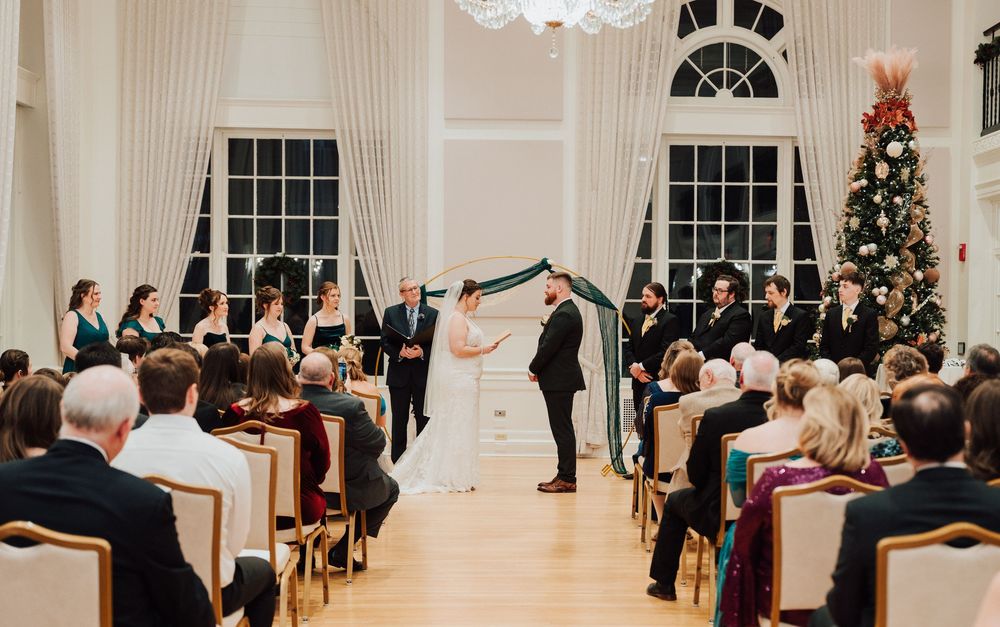 Yorktowne Hotel wedding in York, PA – bride and groom exchange vows during wedding ceremony in ballroom – elegant winter wedding