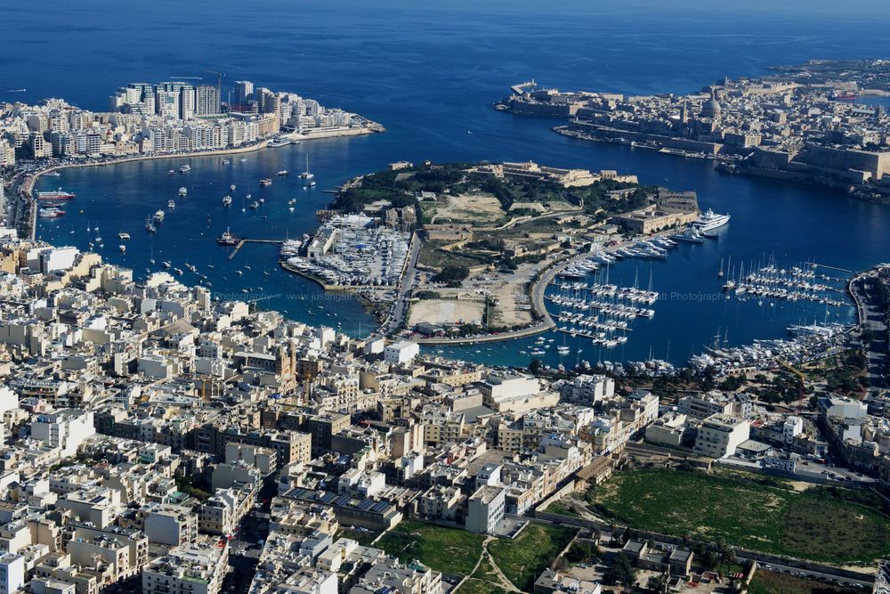 Bird's eye view of Malta's Grand Harbour showing dense urban development and multiple marinas.