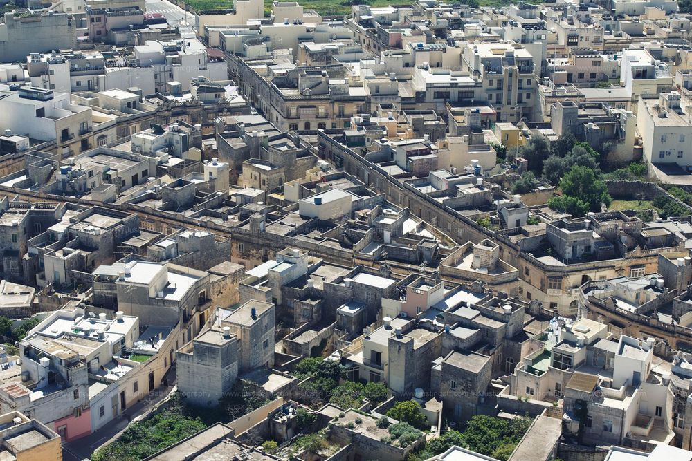 Aerial panorama of a densely packed Mediterranean city with historic architecture and urban development.