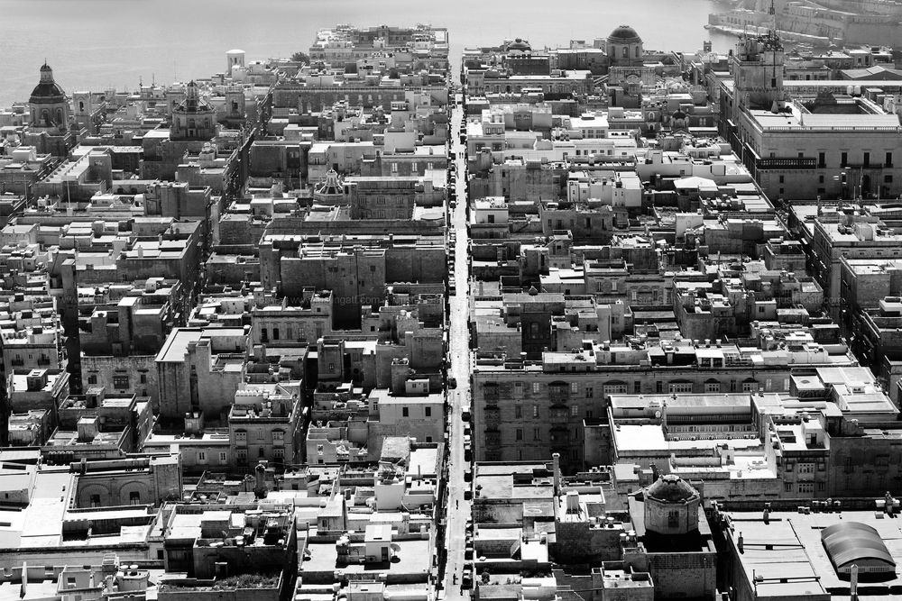 Black and white aerial view of a Mediterranean urban landscape with traditional architecture.