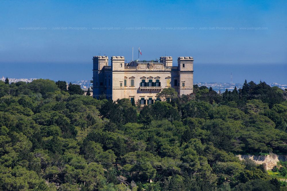 Historic fortress or castle building perched atop a hill against clear blue sky.