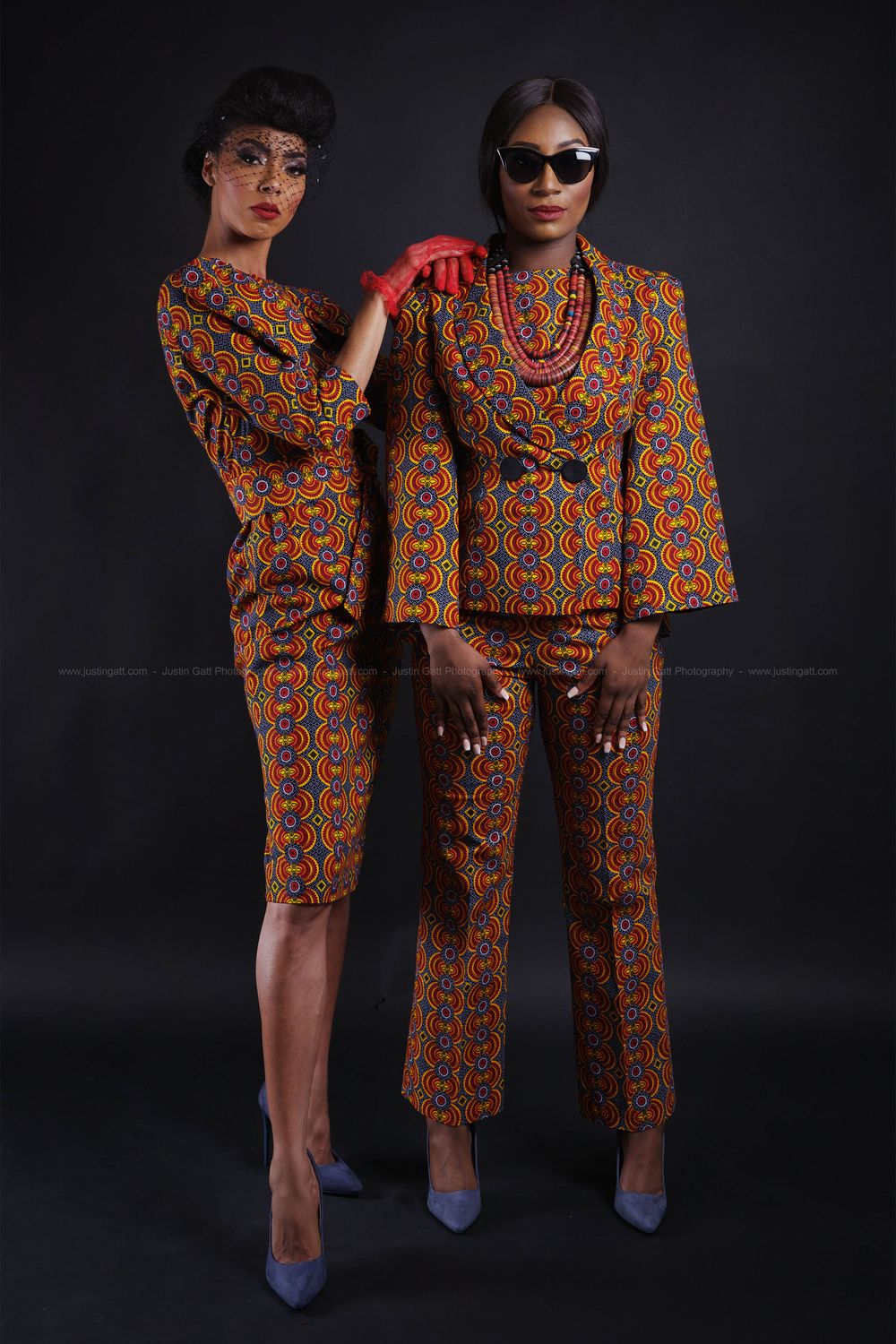 Fashion models showcase vibrant African print coordinated outfits against dark background.