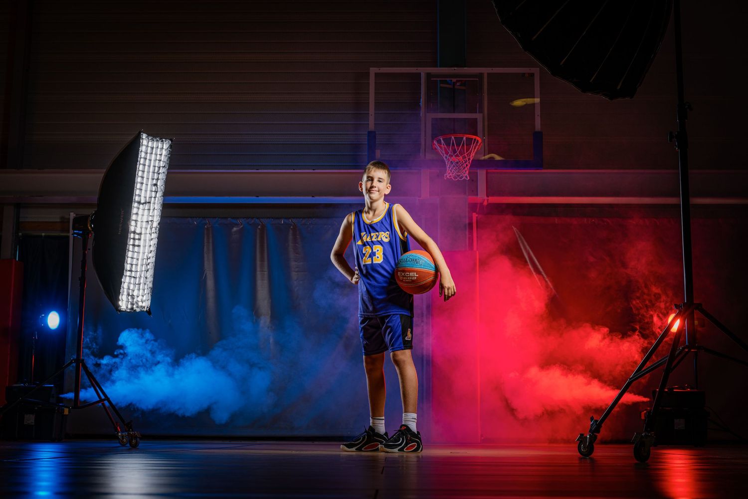 Rugby player in blue jersey holds ball against dark background in dramatic lighting sequence.