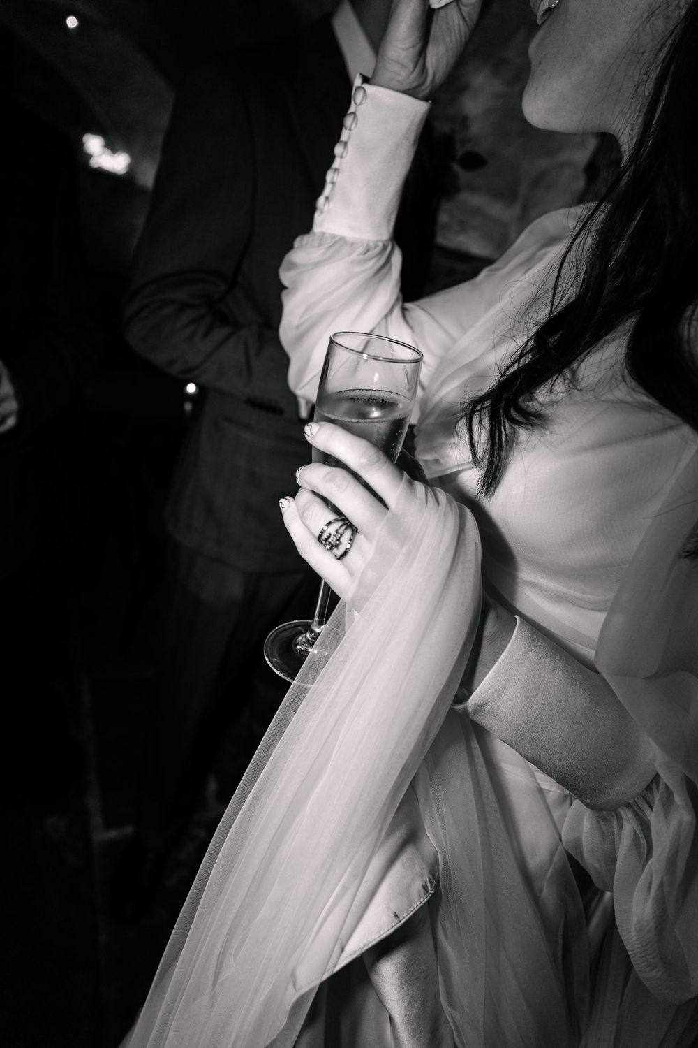Close-up of a couple dancing at a wedding reception, with the bride's white dress flowing elegantly.