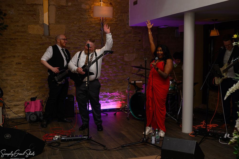 Groom Richard performing with his band at voco Oxford Thames wedding reception