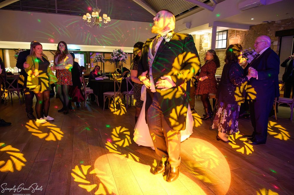 Wedding guests celebrating with traditional Romanian dancing at voco Oxford Thames reception