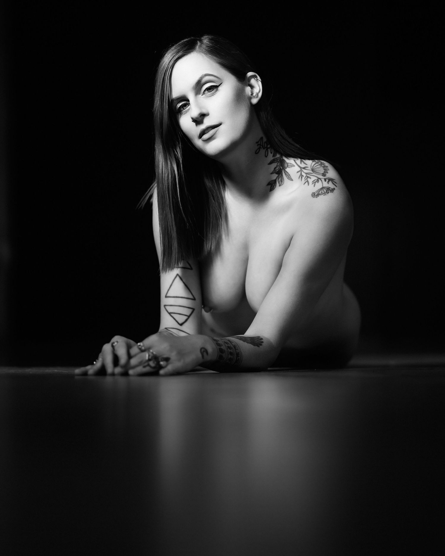 David G Holt Photography - Black and white artistic portrait highlighting geometric tattoo art and dramatic shadows.