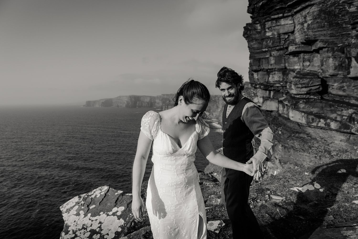 Adventurous couple eloping at Hags Head during golden hour ceremony surrounded by Irish coastal landscape
