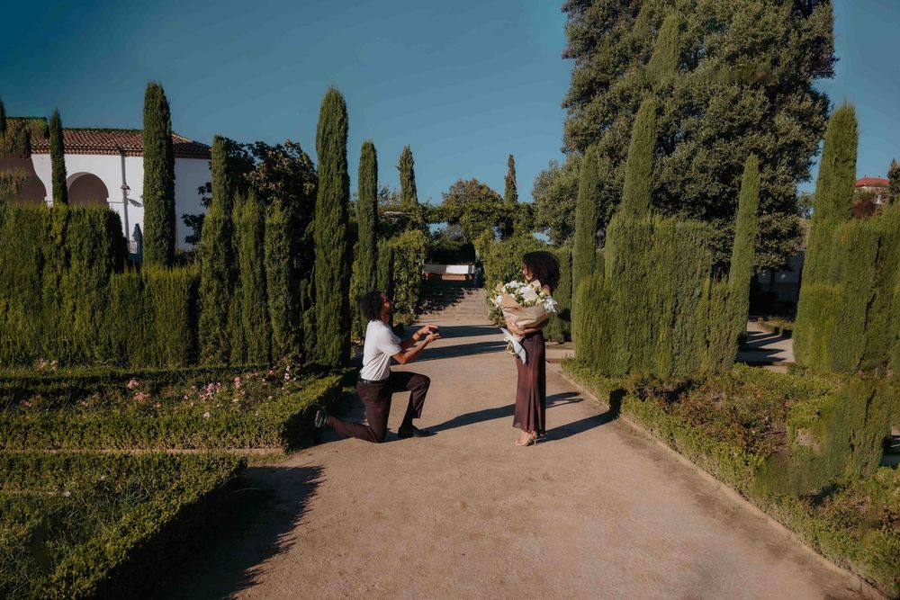 Eunice and Ryan walking hand in hand through the rose gardens.