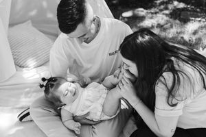 Black and white photo series showing intimate moments between a mother and newborn baby during a hospital birth.