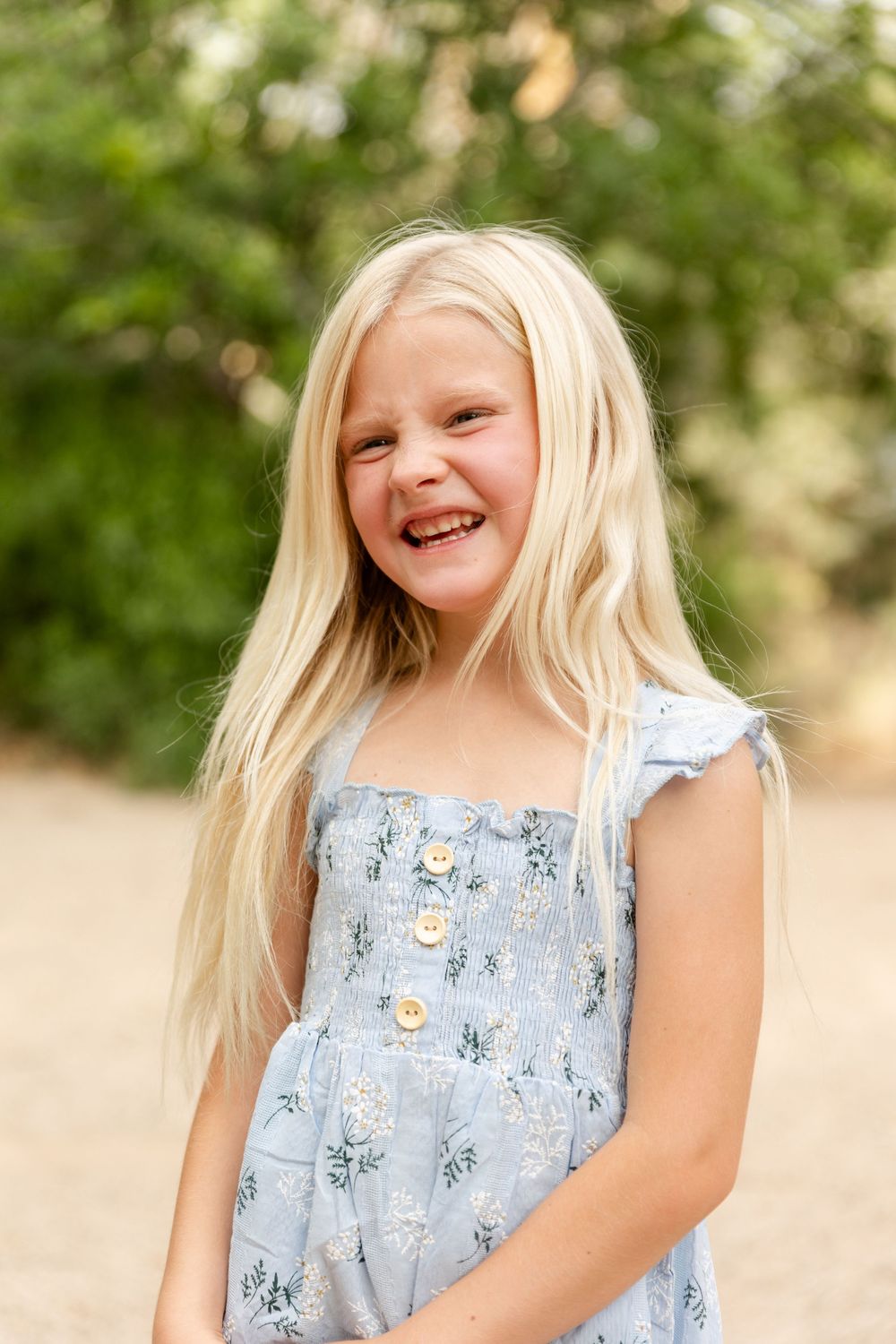 pretty young blonde girl laughing off camera