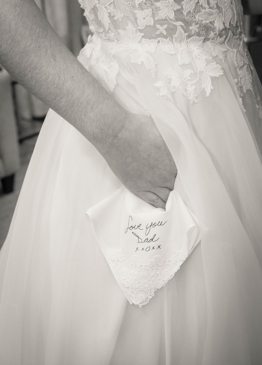 Close-up detail shots of a white wedding dress with handwritten text seen through sheer fabric.