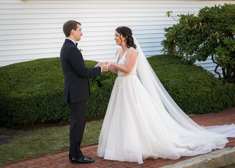 Wedding ceremony sequence showing a couple in formal attire by a white building with shrubs.