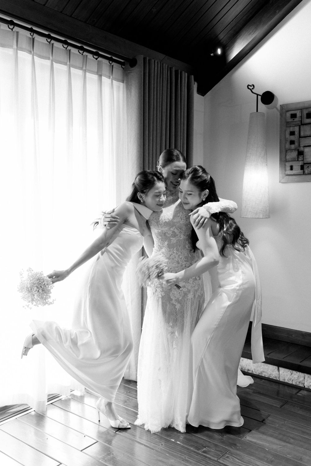 Candid black and white photos of wedding party members dancing and celebrating together.