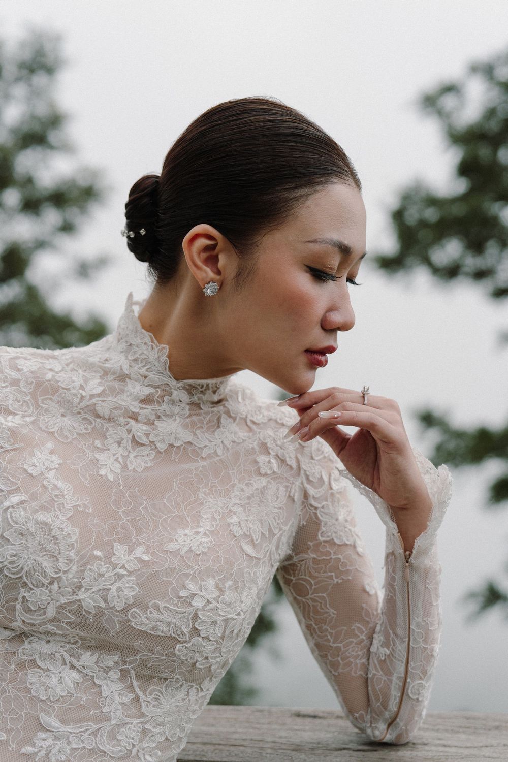 Close-up portrait of an elegant bridal look featuring delicate lace details and soft makeup.