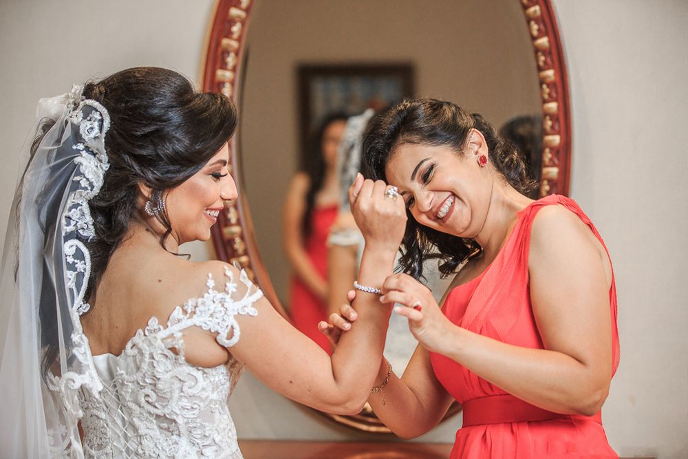 Joyful wedding celebration moment with bride and guests sharing laughter.