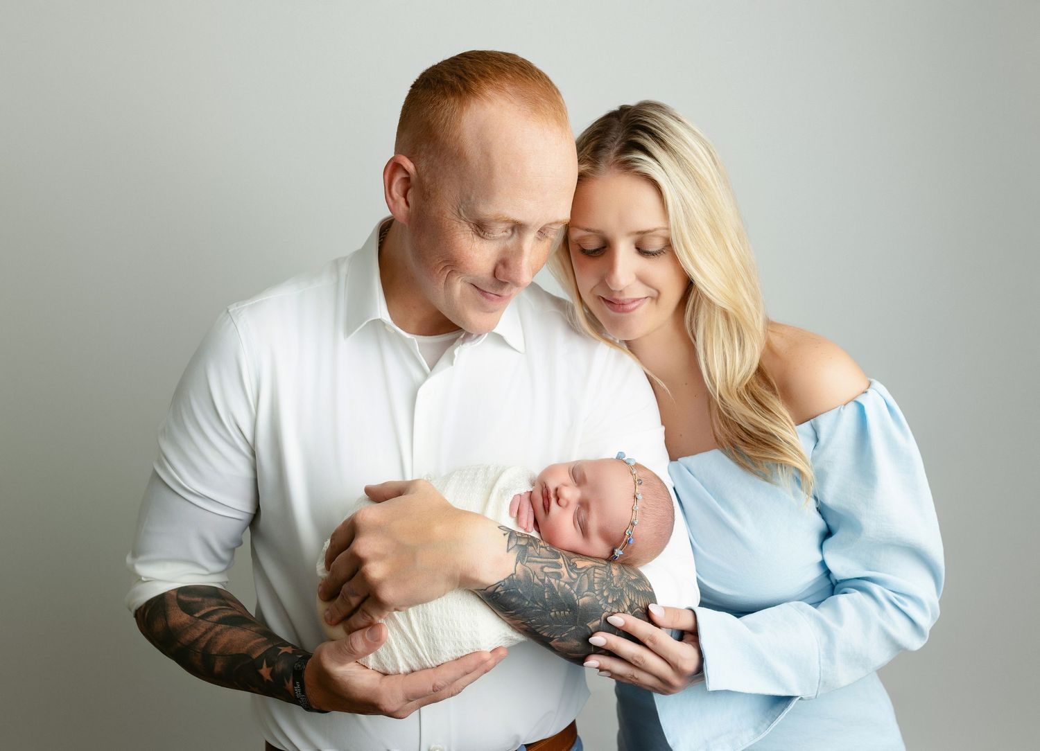 Dad and Mom is holding the newborn baby girl very tenderly. - Greenville SC newborn photographer - Easley SC newborn photographer