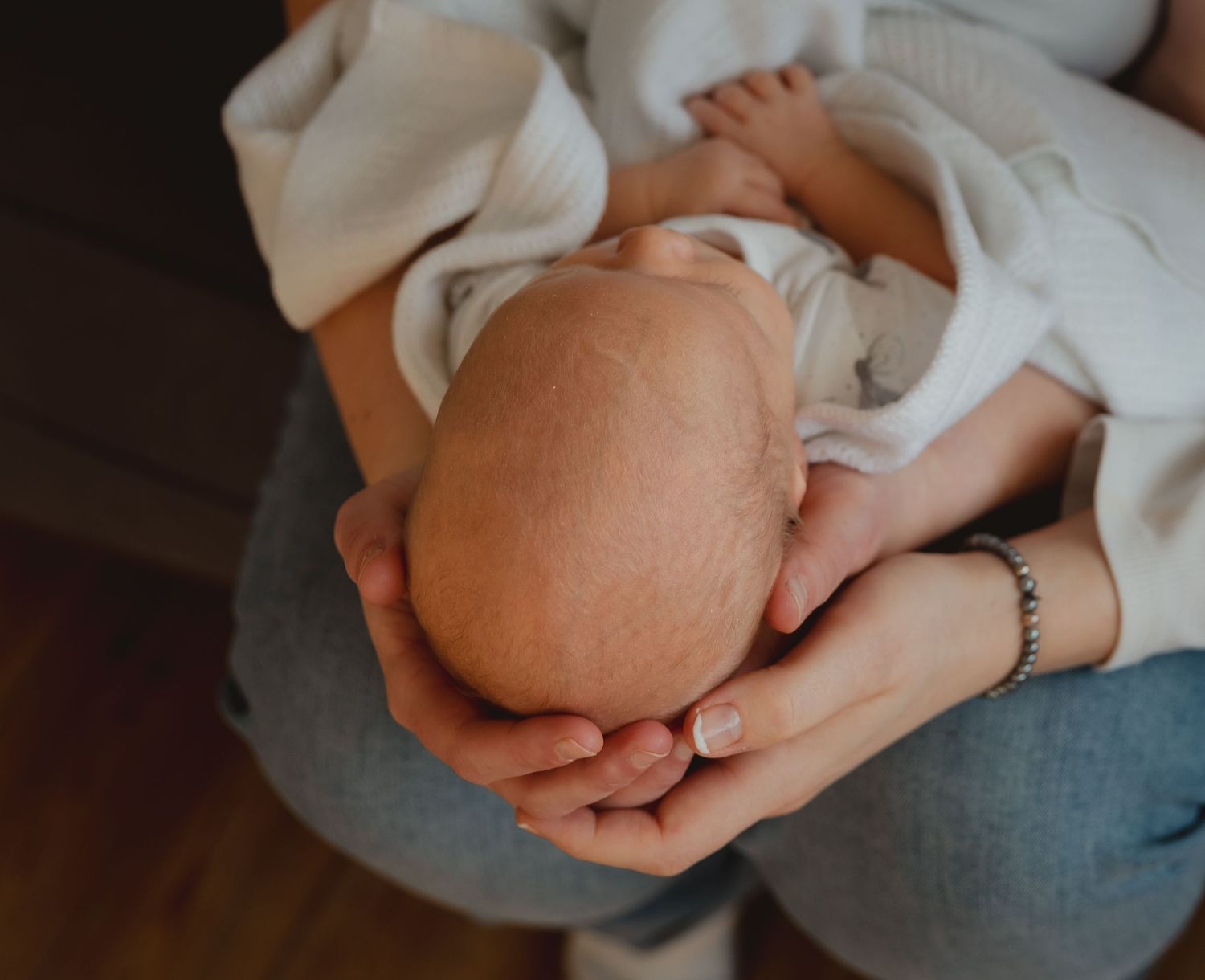 Two mums hold their newborn baby boy