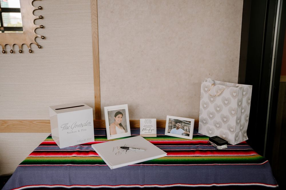 Open spiral notebook with blank pages lying on a dark surface with other paper materials scattered nearby.