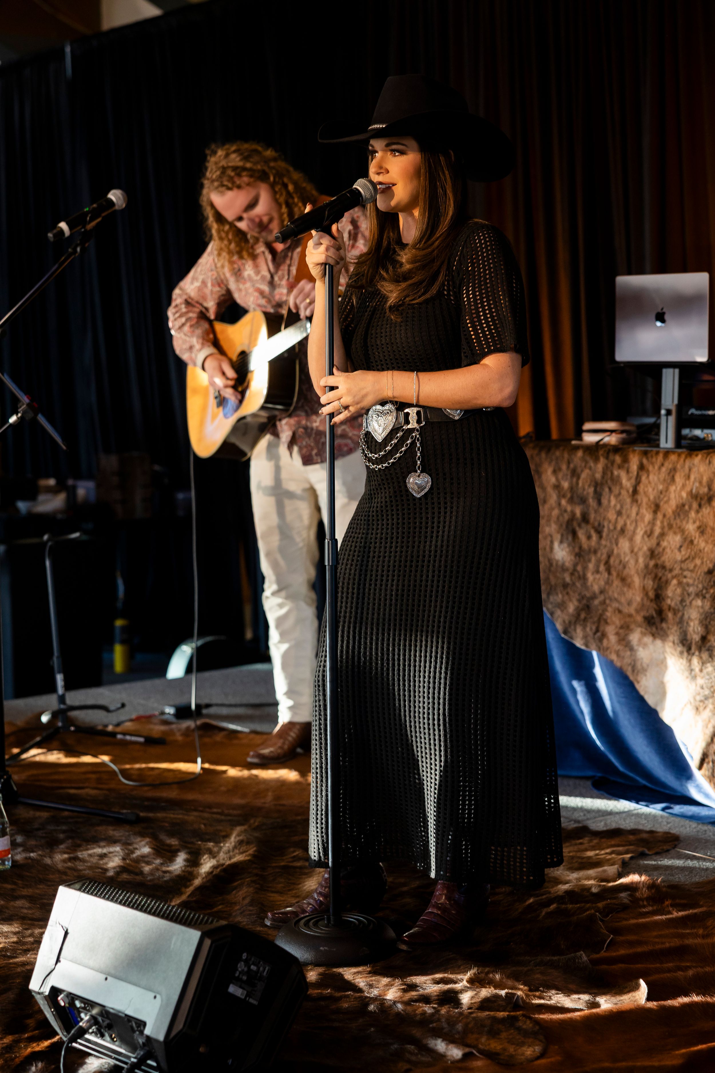 Performance on a dimly lit stage with musical instruments.