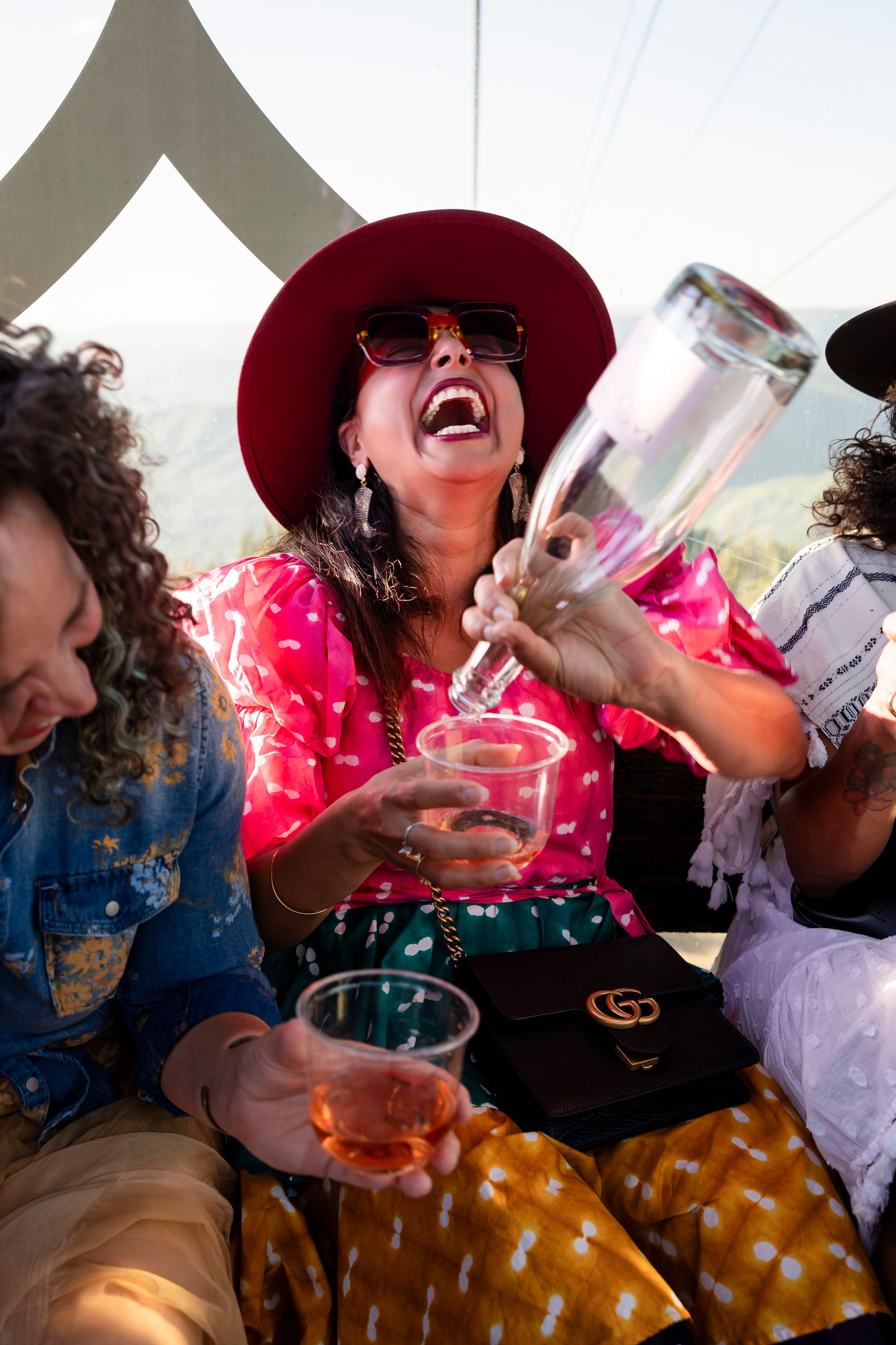 Casual friends sharing drinks and laughter during a social gathering.