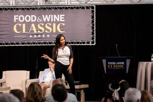 Food and wine event stage setup with banners and lighting equipment.