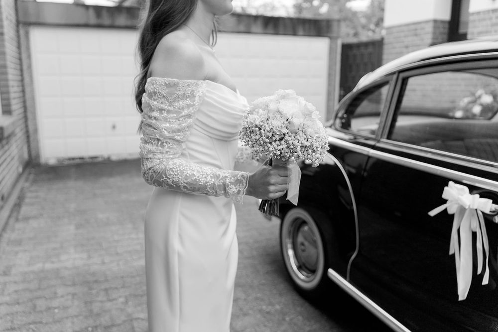 Glimpses of a classic car and formal attire details in black and white.