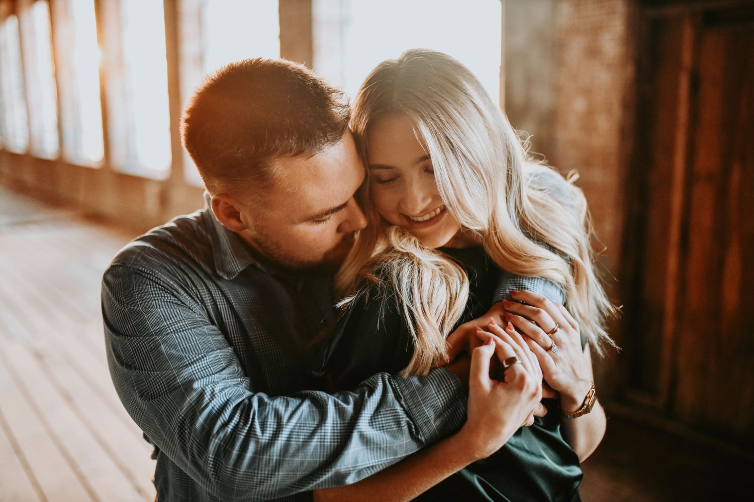 Couple embracing during sunset proposal at McKinney Cotton Mill