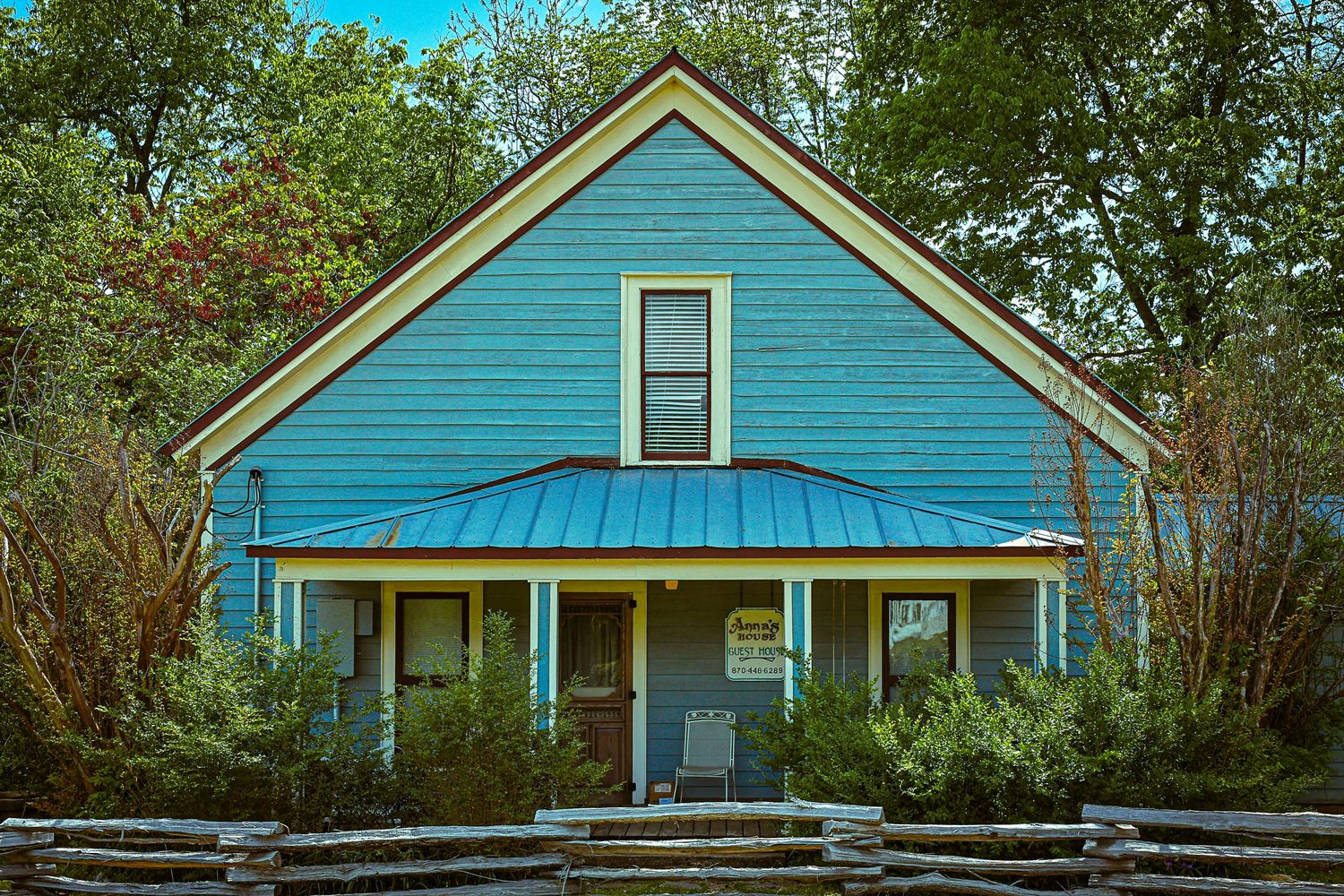 A sequence of outdoor photographs showing different angles of a blue painted residential house with white trim.