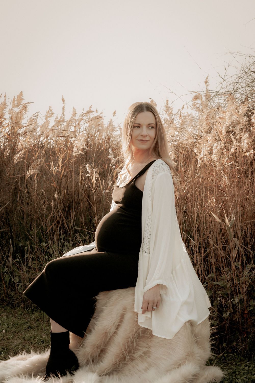 A maternity portrait featuring a black dress and white cardigan against dried grass.
Altona Family Photographer Melbourne