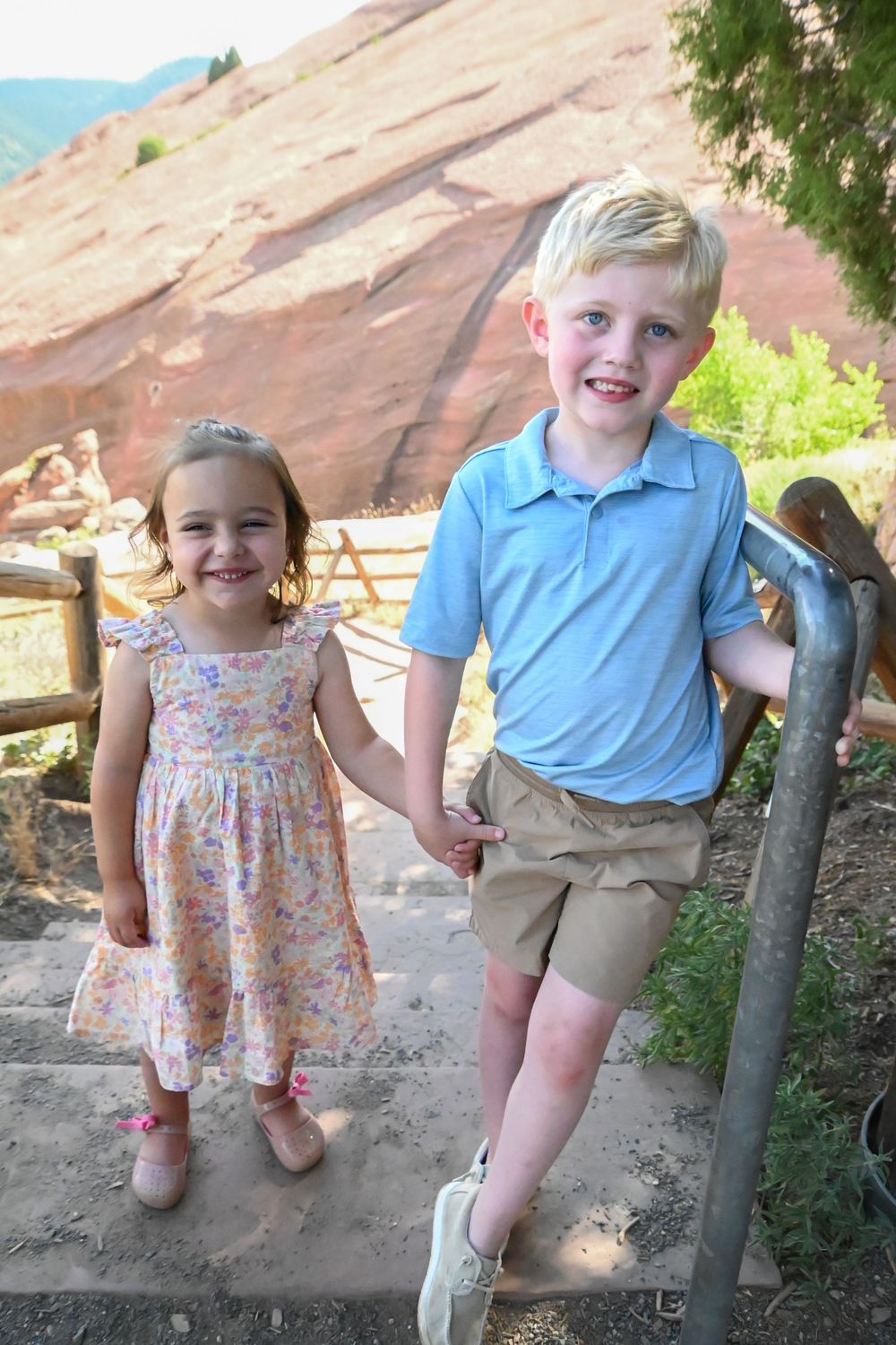 Two children enjoying a sunny day at Red Rocks Park in Colorado.