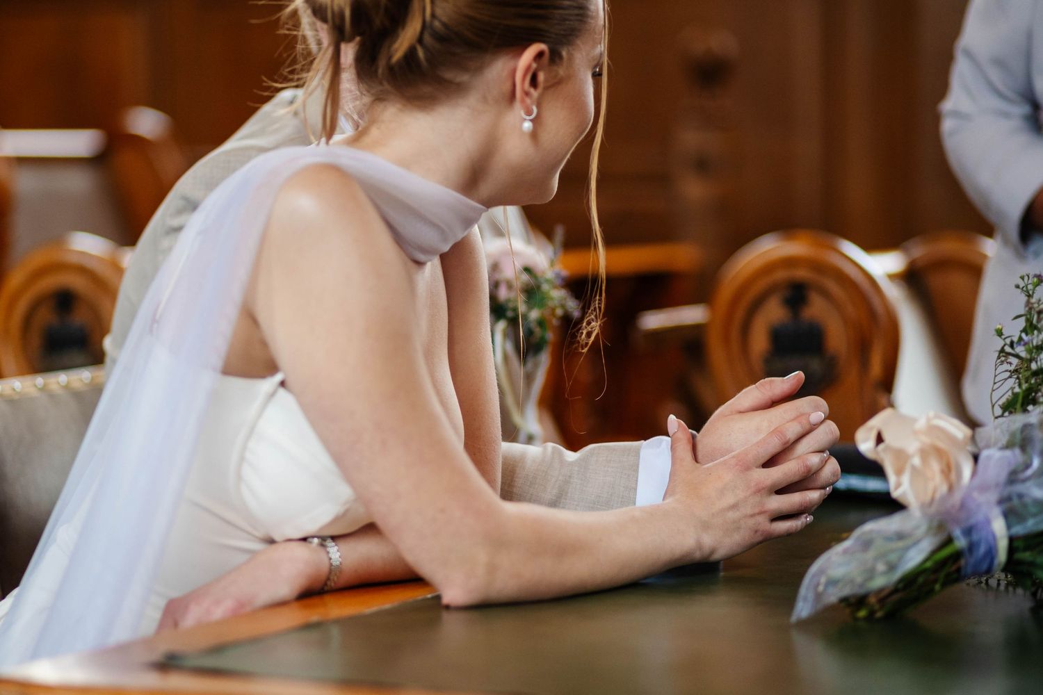 slight touch of hands, candid moment capture by Lynette Matthews Photography at Southport Town Hall.