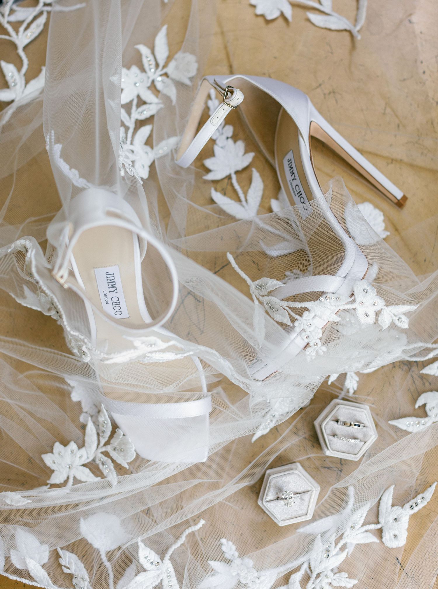 Elegant white wedding Jimmy Choo shoes and rings at Castel Bay, Hyères, French Riviera.
