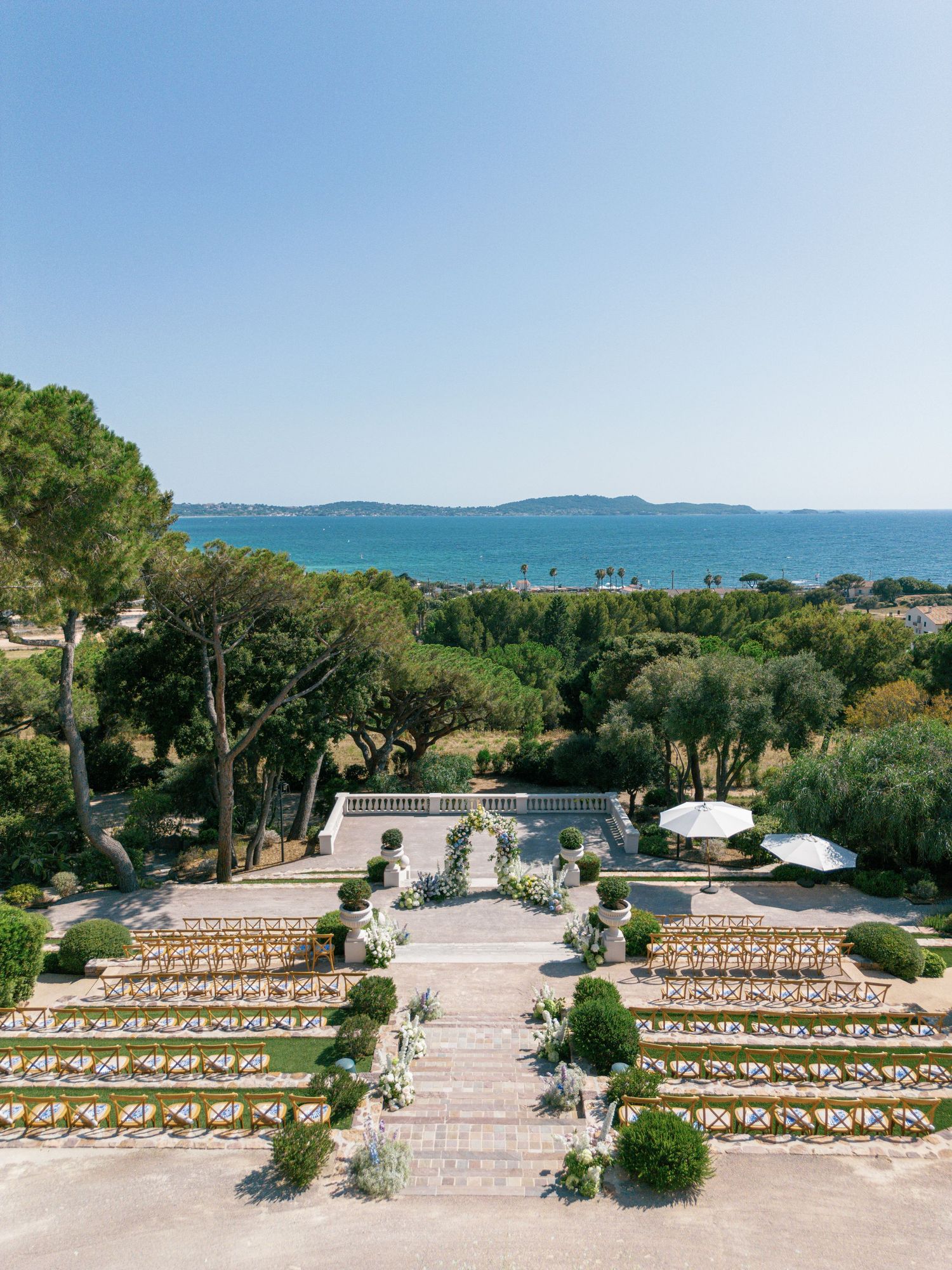 Panoramic view of an outdoor wedding ceremony setup overlooking scenic sea view at Castel Bay, Hyères, French Riviera.