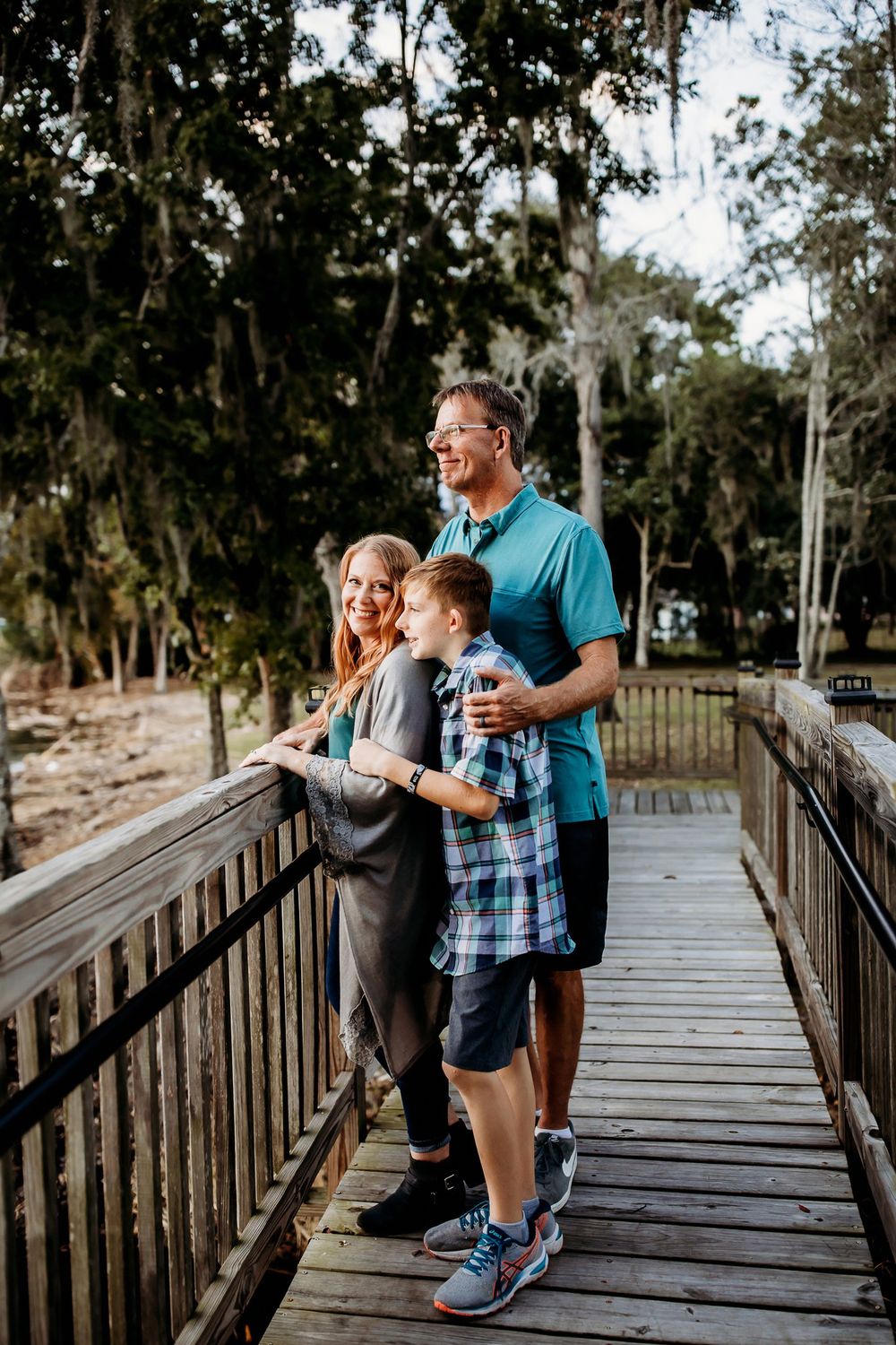 Three sequential photos show a joyful moment between family members on a rustic wooden boardwalk surrounded by trees.