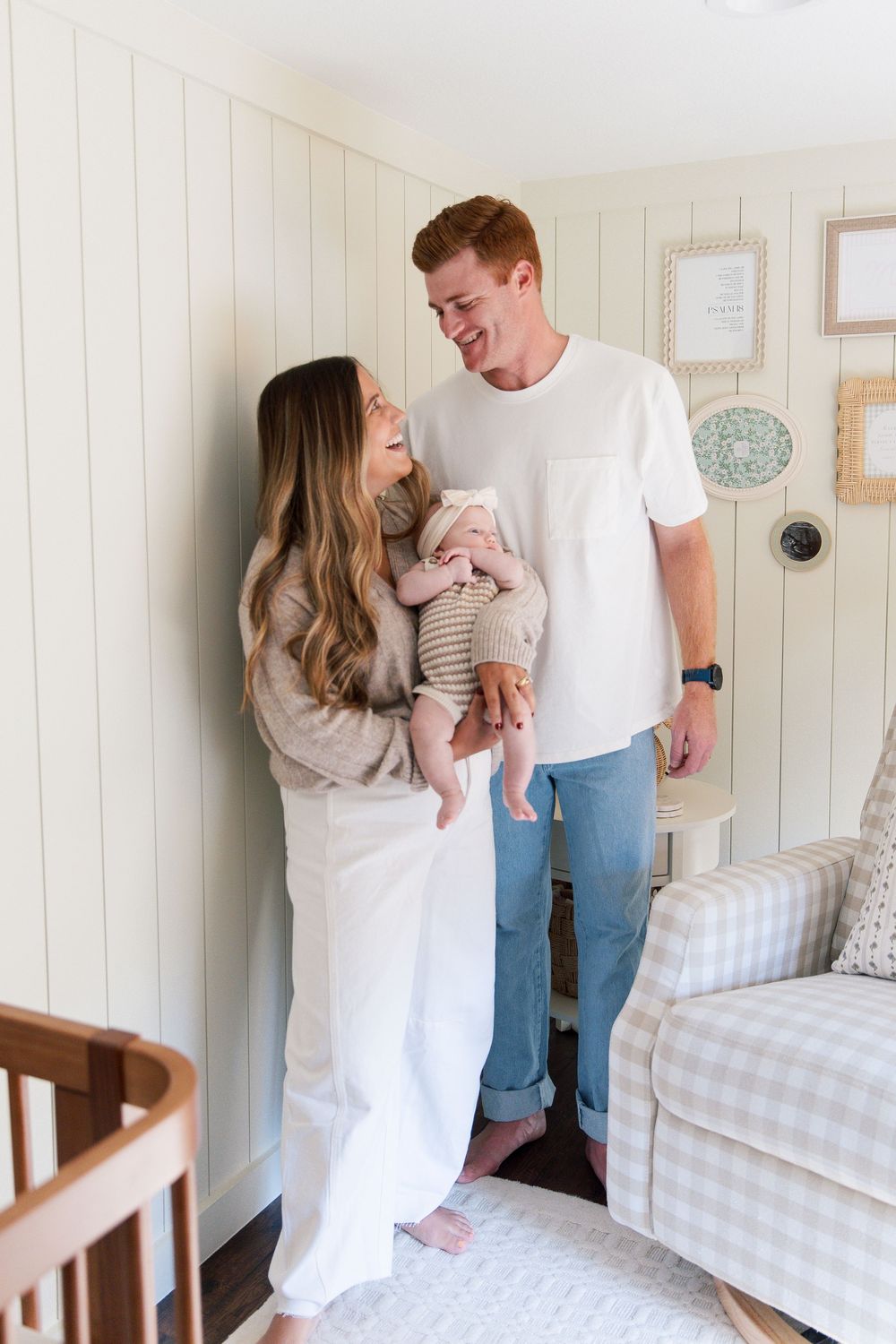 Family lifestyle session in white paneled nursery showing tender moments with baby.