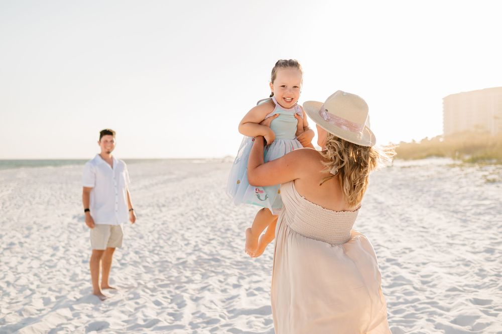 Joyful family moment captured during sunset on a pristine beach.