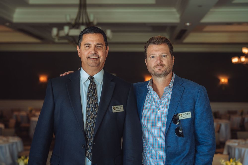 Business professionals in suits gathered at a formal networking event.