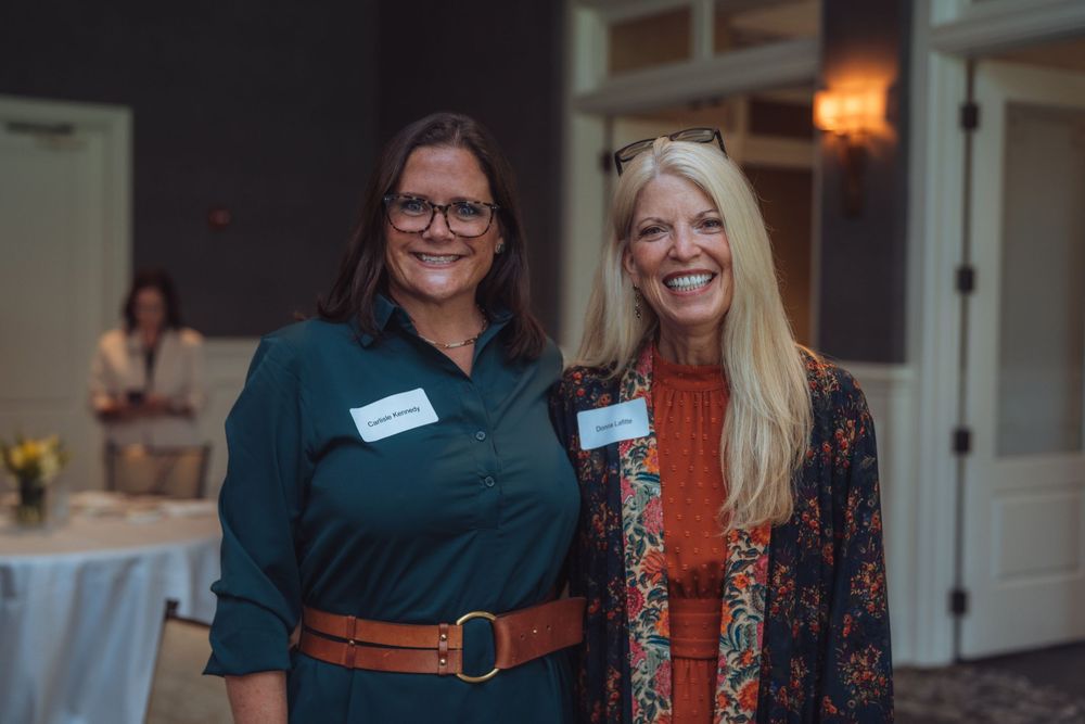 Professional networking event with attendees mingling in a business setting.