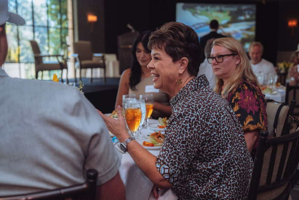 Attendees enjoying drinks and conversation at a business gathering.