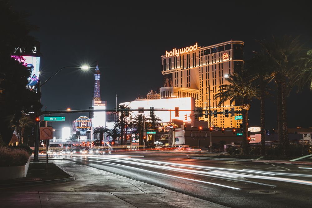 Las Vegas Strip at night with illuminated hotels and casinos creating a glowing cityscape.