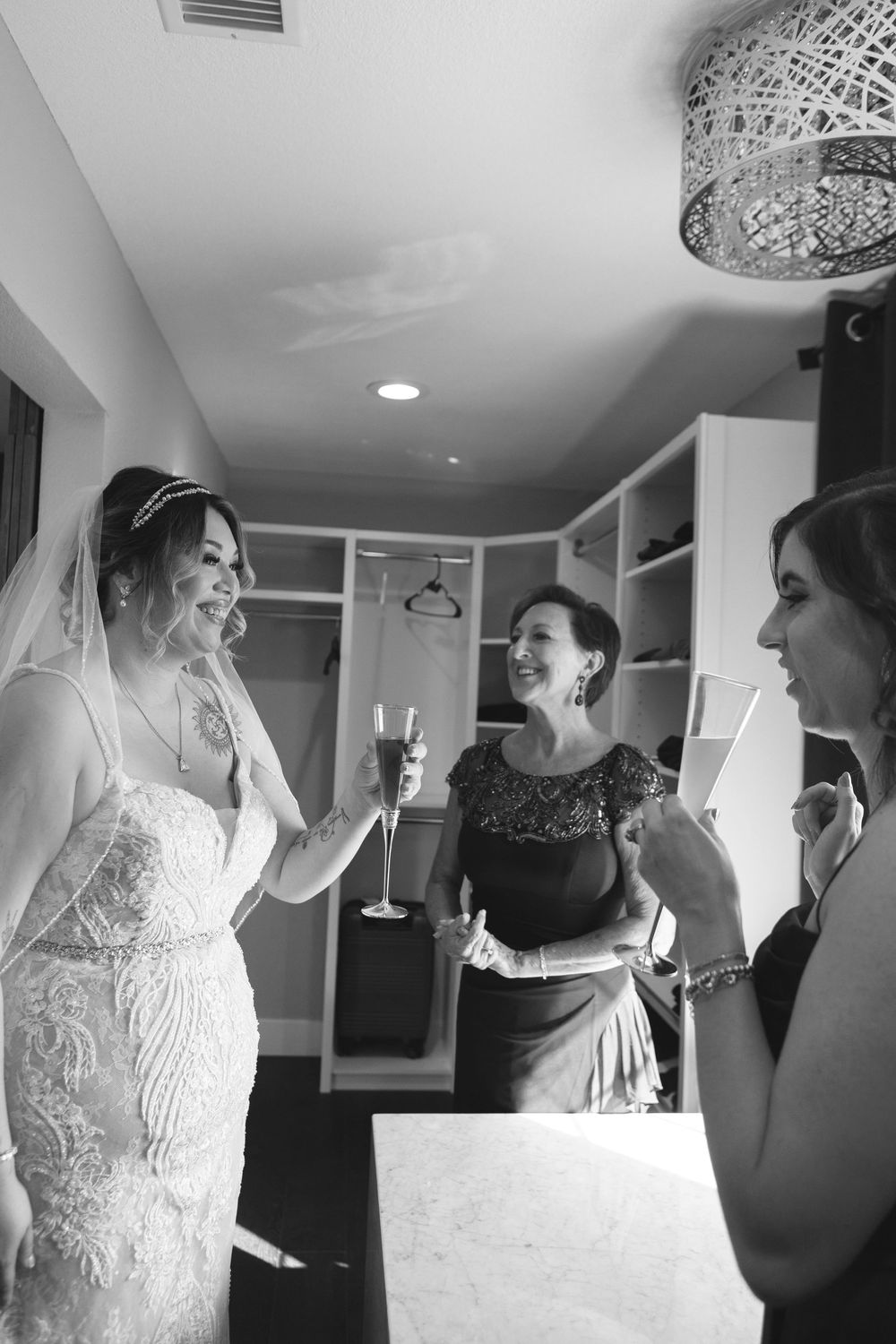 Bride with mother and bridesmaid toasting during getting ready photos at Las Vegas Airbnb