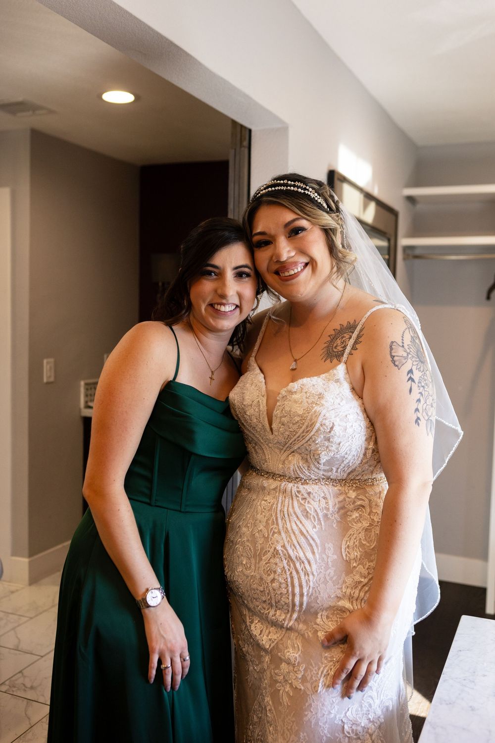 Bride hugging bridesmaid during getting ready photos