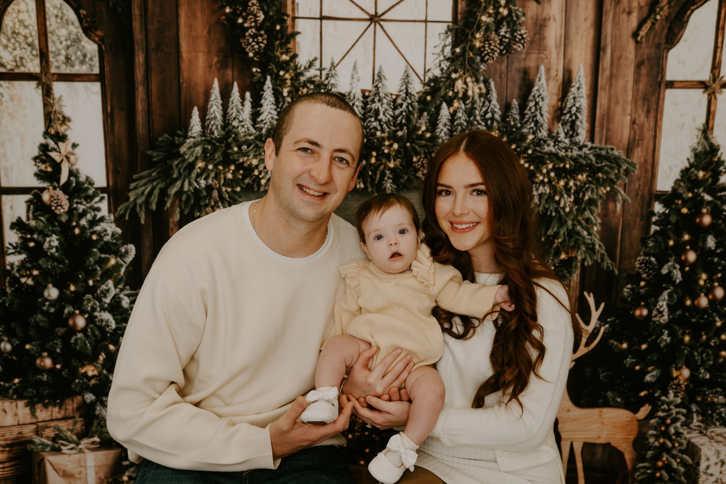 Cozy family photo session with holiday decor and twinkling lights.