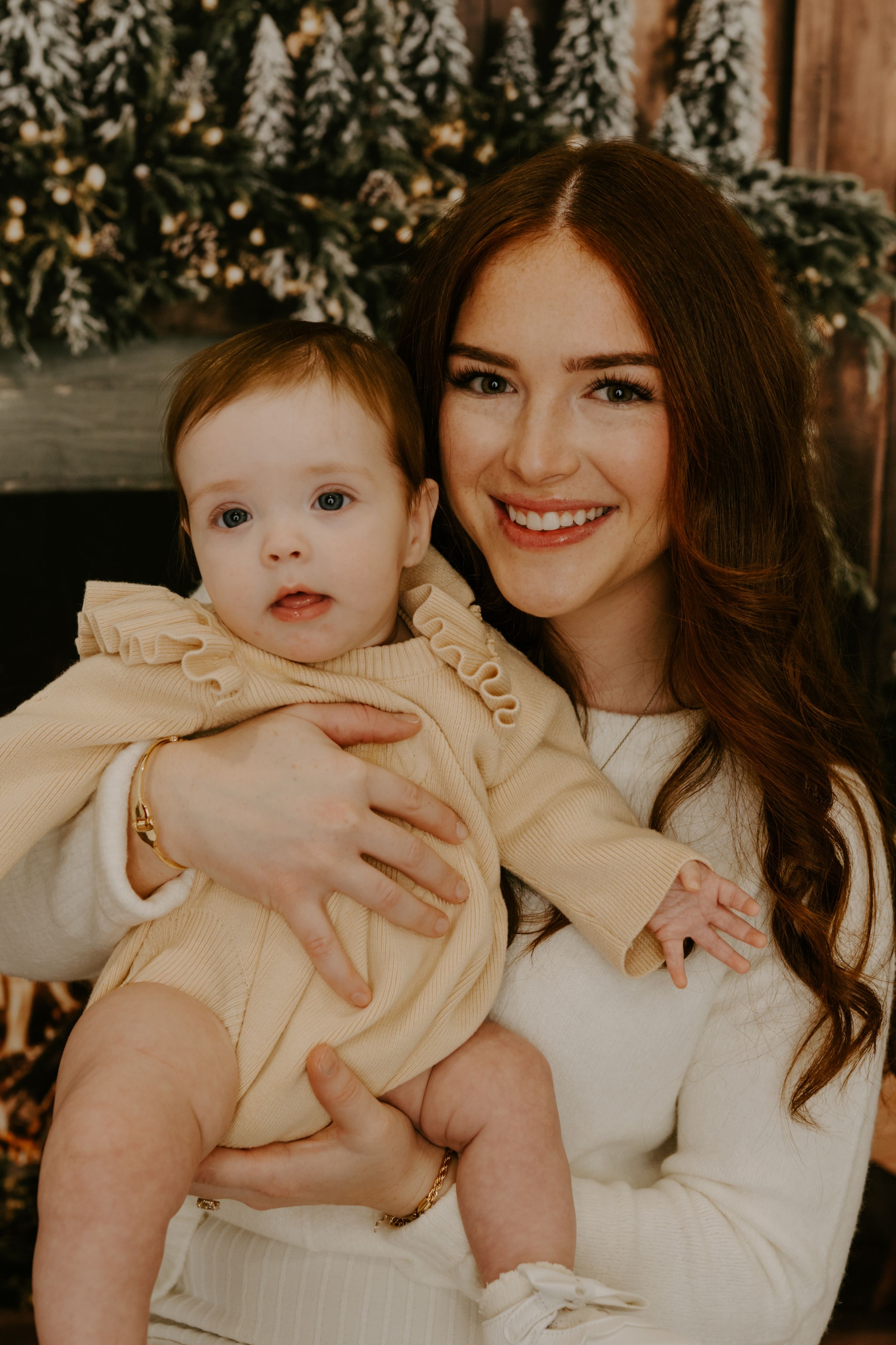Intimate family portrait with soft lighting and holiday decorative elements.