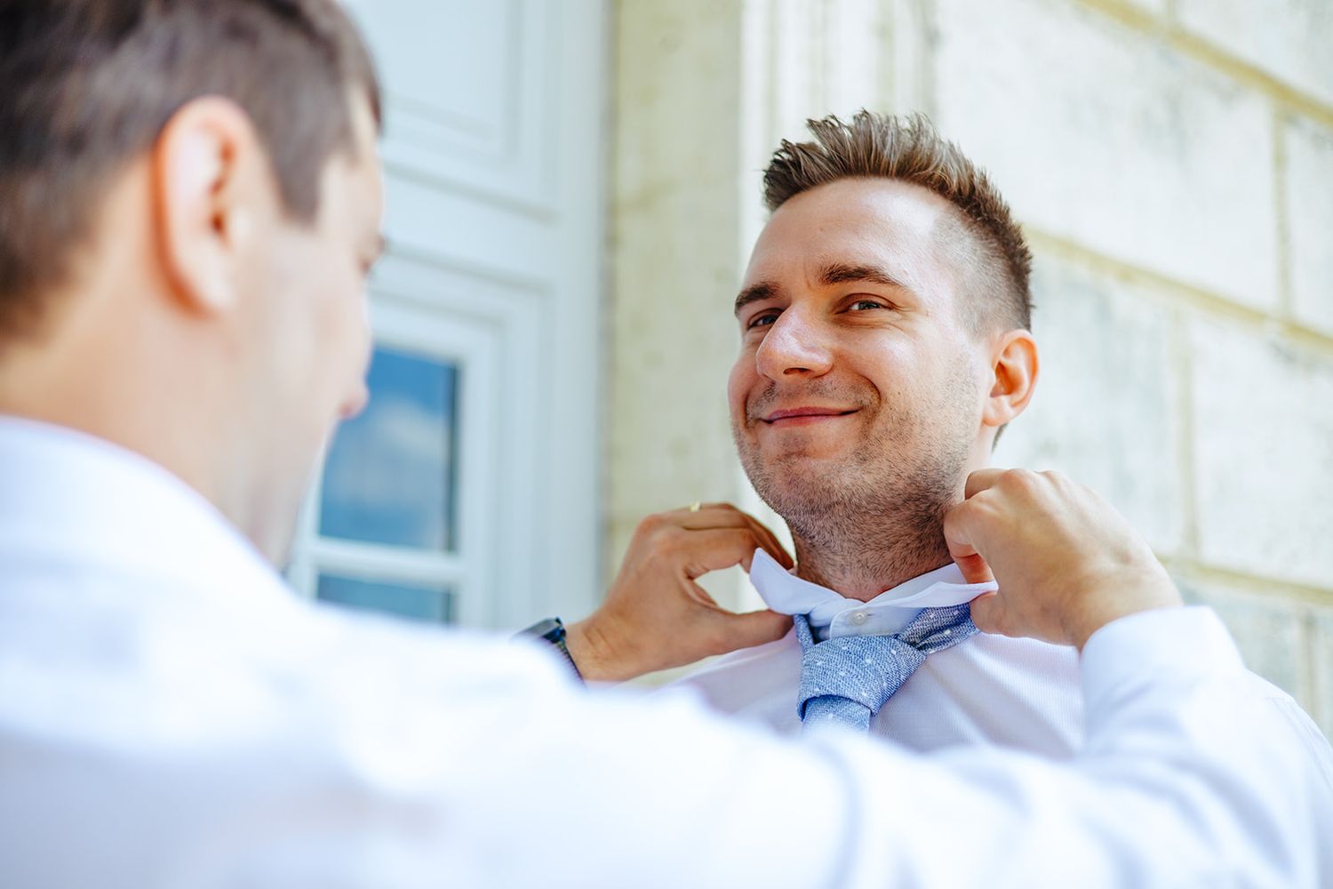 Professional conversation between two businessmen in a bright office setting.