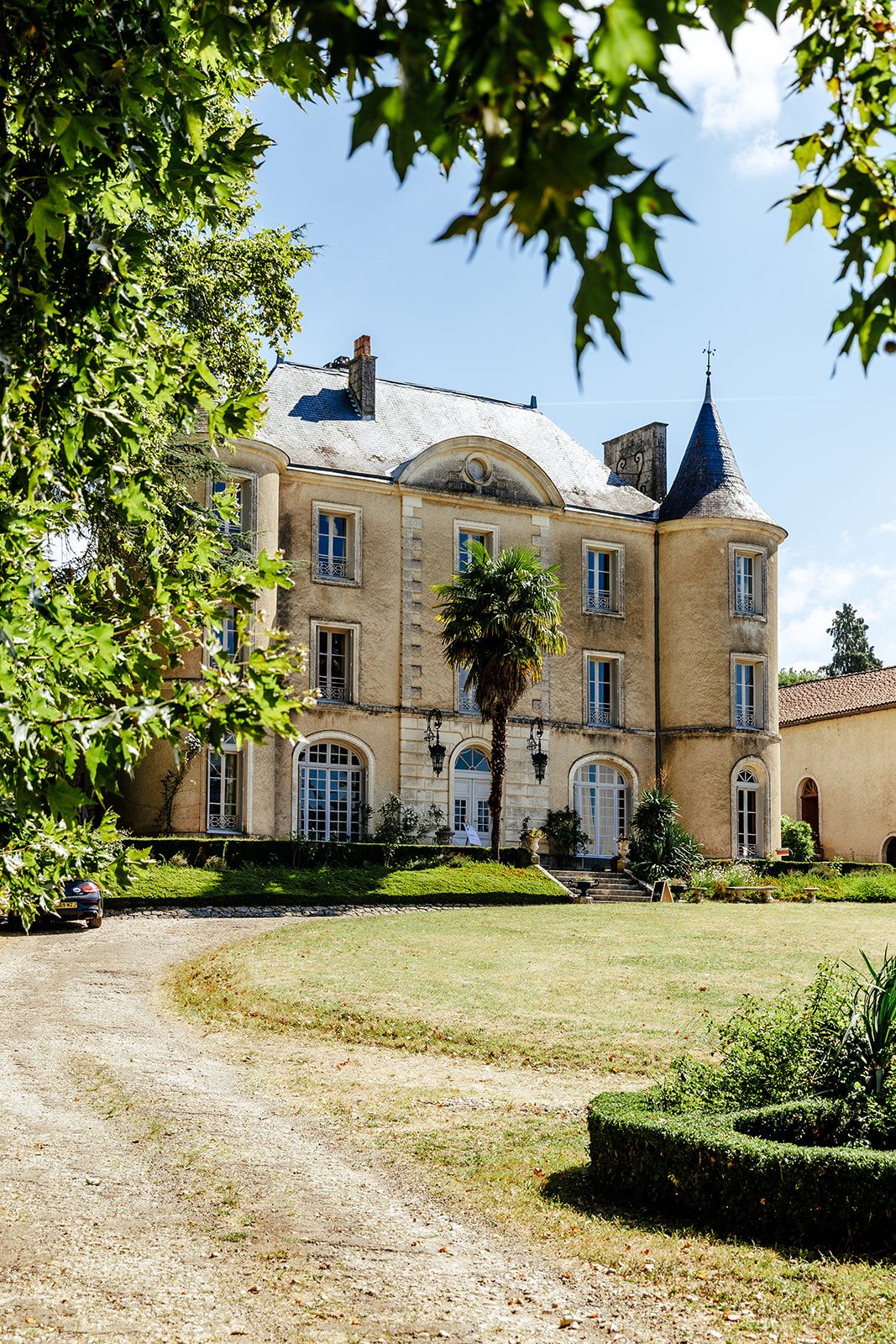 Elegant French chateau with stone facade and arched windows viewed from multiple angles along a gravel driveway.