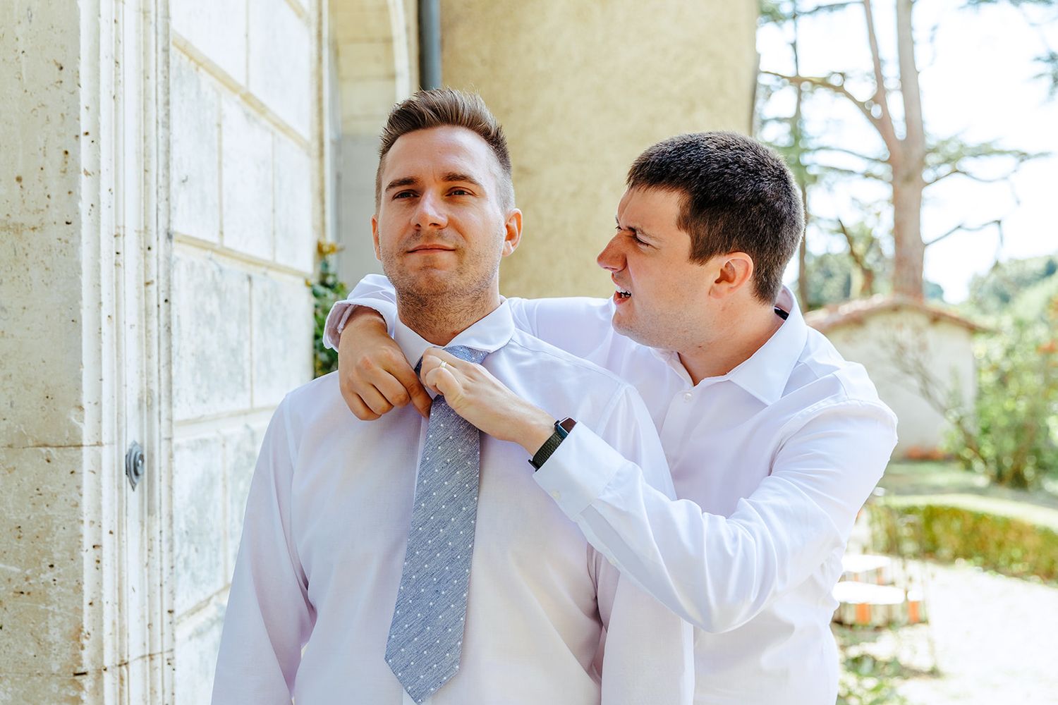 A collage of candid wedding moments showing laughter and joy between people in formal attire outdoors.
