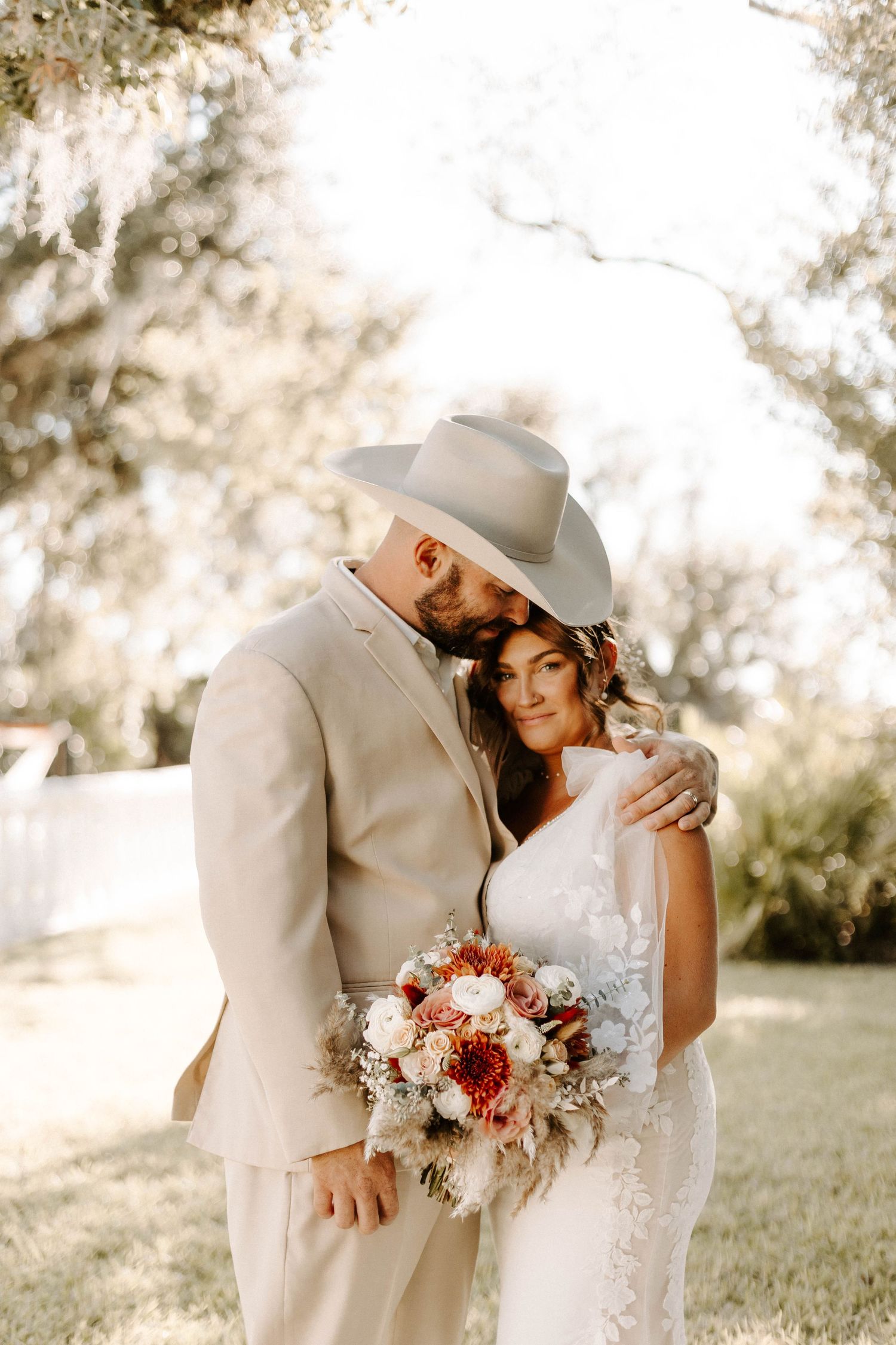 A romantic outdoor wedding photo series showing a couple in beige and white attire embracing in soft sunlight.